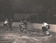 Bruins Brimsek, #6 Jack Crawford and #18 Art Jackson defend against Bryan Hextall and #3 Ott Heller of the Rangers. Game 1 of the 1940 Semi-finals, March 19, 1940.