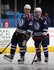 Tony Granato #21 and Shelley Looney #15 of the USA Legends skate in warmups prior to playing against the Canada Legends at the Legends Classic Hockey Game at the Air Canada Centre on November 7, 2010 in Toronto, Canada