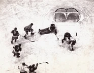 Rangers Dave Kerr stops John Gallagher. #9 Lynn Patrick, #3 Ott Heller, #11 Sweeney Schriner, #2 Art Coulter on December 16, 1937.