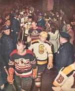 Hawks Robert "Red" Hamill]] and Bruins Jack Crawford head onto the ice in an early 1948 game.