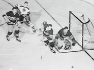 Bruins Don McKenney and Canadiens Jacques Plante, Tom Johnson and Bert Olmstead during Game 4 of the 1955 Semi-finals, March 29, 1955.