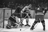 Jack McCartan stops Bobby Hull, March 9, 1960.