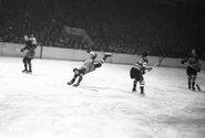 Rangers Bert Connelly trips over Americans Al Murray, January 27, 1935.