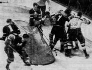 Flash Hollett and Milt Schmidt scrum with Nick Metz and Rudolph Kampman, November 17, 1940.