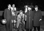 President Calder presenting the 1942 Stanley Cup to Conn Smythe and Leafs Captain Syl Apps.