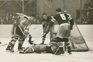 Milt Schmidt is stopped by Jim Henry, November 15, 1941.