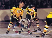 1962-Mohns Burns Henry.jpg (343 KB) Doug Mohns and Charlie Burns battle Camille Henry in the 1959 pattern gold jersey.