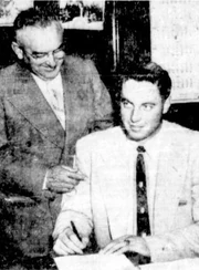Beliveau signs his first Canadiens' contract in 1953 as  looks on.