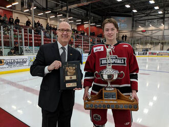 Justin Lee receives Vince Leah Trophy from Commissioner Kim Davis