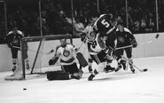 #26 Dunc McCallum checks #5 Carol Vadnais as Les Binkley makes a save, Quarter-finals Game 4, April 12, 1970.