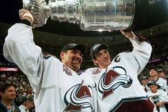 Teammates Joe Sakic and  celebrate with the Cup.