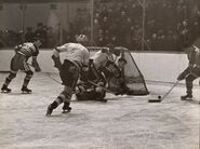 Hawks #11 Jack Portland, goalie Paul Goodman and #8 Joe Cooper defend against the Bruins, November 12, 1940.