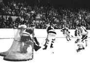Harry Lumley, #4 Bob Armstrong and #15 Ab McDonald in 1959-60 action. Note the gold pants with black jerseys and socks.