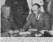 Eddie Shore signs a contract negotiated with Frank Calder, November 16, 1938.