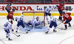 The  (white) defend their goal against the  (red) during the first round of the .