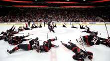 Hurricanes players celebrate on the ice after a playoff win over the 