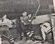 A rare action photo of the Bruins alternate 1940's jersey. Bruins Jack McGill hunts for a rebound on Chuck Rayner and Tommy Anderson of the Brooklyn Americans during the 1941-42 season.