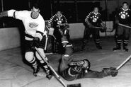 Gordie Howe with goalie Chuck Rayner and Bill Quackenbush, 4th NHL All-Star Game, October 8, 1950.