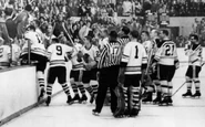 Ed Litzenberger goes into the stands at the Boston Garden assisted by #9 Tod Sloan and #2 Al Arbour, October 23, 1960.