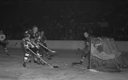 Willie O'Ree shooting on Glenn Hall while being checked by Bill Hay, December 28, 1960.