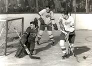 Gerry McNeil, Sid Abel, Vic Stasiuk in 1950-51 season action. Note the City of Detroit 250th anniversary patch.