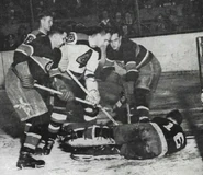 Montreal's Paul Bibeault wears a Detroit Red Wings jersey and stops Boston's #4 Herb Cain, November 17, 1942.
