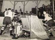 Earl Robertson makes a save while #4 Wilf Field looks on, January 26, 1939.