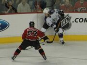 Langkow fighting for the puck against  of the .