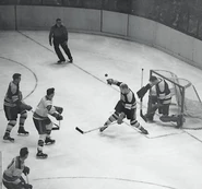 Goalie John Henderson playing his first NHL game is assisted by Bob Armstrong against the Rangers, November 17, 1954.