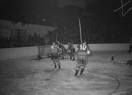 Mel Hill scores on Bill Durnan to cut Habs lead to 2-1. #4 Lamoureux and #10 Kennedy look on.