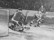 Don Gallinger scores the series winner OT goal on Detroit's Harry Lumley while Ted Lindsay watches on March 28, 1946.