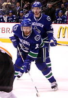 The Sedins with the . Burke drafted both players in the first round of the  as the general manager of the Canucks.
