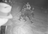 Wally Kilrea battles #8 Jack Portland, January 31, 1937. Notice that 3 players are wearing helmets.