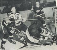 Frank Brimsek makes a save while #19 Murph Chamberlain battles the Red Wings during Game 3 or 4 of the 1943 Stanley Cup Finals.