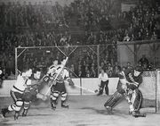 6Jan1946-Rayner clears puck, Cowley Cain