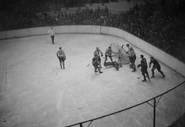 Frank Brimsek makes a save in a 1939 Stanley Cup Finals game in Boston while #2 Eddie Shore, #10 Bauer look on.