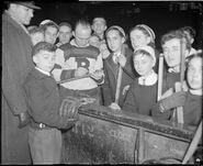 Eddie Shore signs autographs at the December 16, 1934 Hockey Clinic at the Boston Garden.