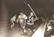 Leo Labine battles Eric Nesterenko in the 1953-54 season.
