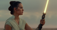 Rey with her own lightsaber