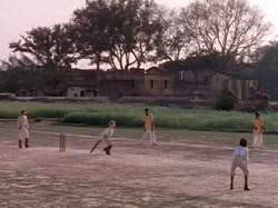 A young Indiana Jones playing cricket in India.