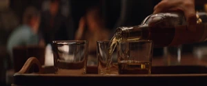 Eric pours some whisky to the Basterds.