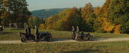 The two bikers carry MP40s