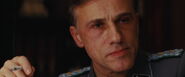 Hans Landa looks at Shosanna serious