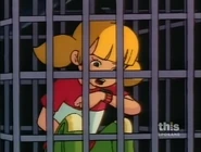 Penny talking to Brain on her wristwatch whilst locked inside a cage in the boiler room of a cruise ship