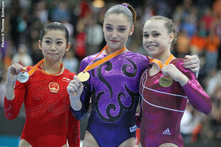 Mustafina (center) with her World All-Around gold medal