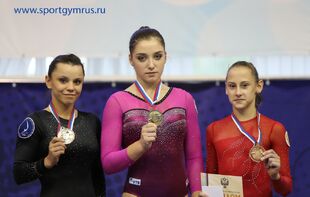 Mustafina (center) with her Russian Cup Floor Exercise gold medal