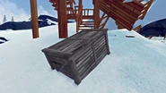 The large supply crate under the supports