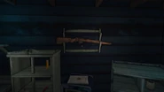 A hunting rifle on the rack in the Trapper's Homestead
