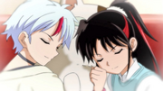 Setsuna and Towa hugging a stuffed toy cat.