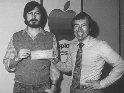 steve jobs holding apple